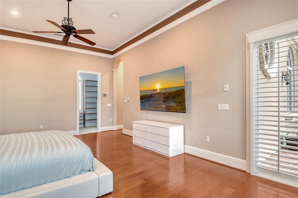 591 Putting Green Lane Longboat Key, FL 34228 - Photo 30 of 68 a bedroom with a bed and a flat screen tv