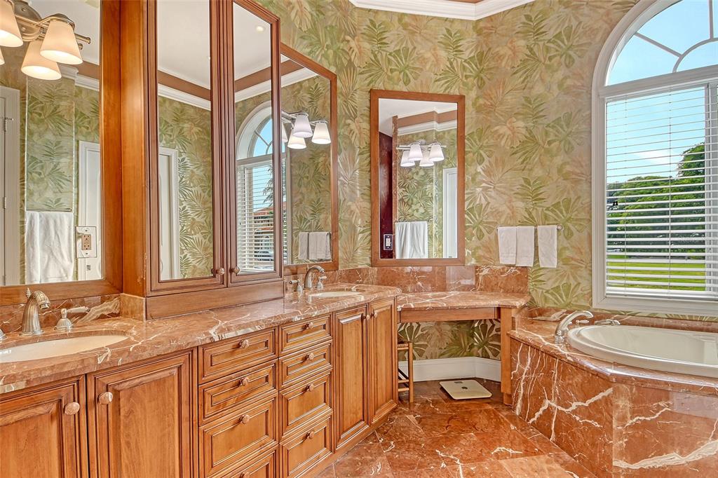 591 Putting Green Lane Longboat Key, FL 34228 - Photo 31 of 68 a bathroom with a granite countertop sink and a large mirror