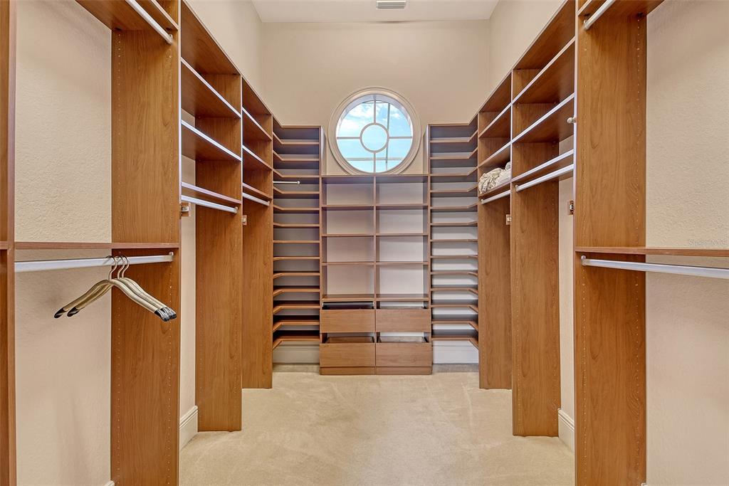 591 Putting Green Lane Longboat Key, FL 34228 - Photo 35 of 68 a view of walk in closet with clothes and shoes