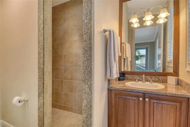 a kitchen with stainless steel appliances granite countertop a sink a stove and a refrigerator with wooden cabinets