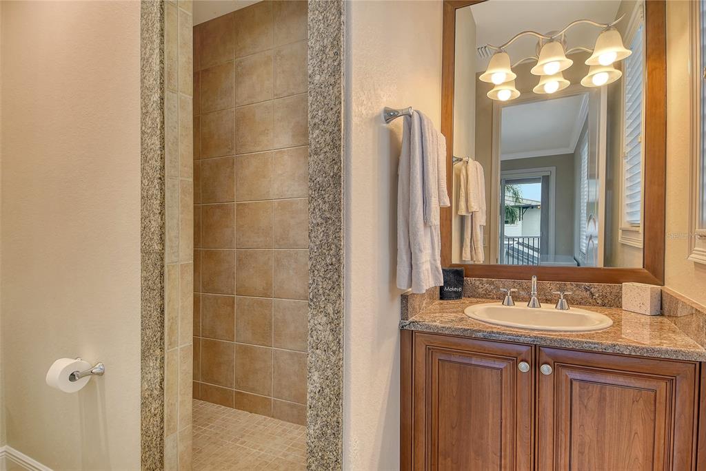 591 Putting Green Lane Longboat Key, FL 34228 - Photo 43 of 68 a bathroom with a sink vanity and a mirror