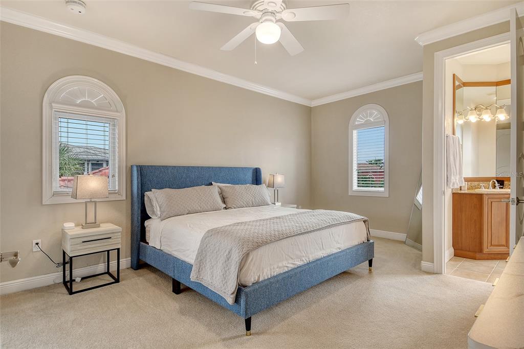 591 Putting Green Lane Longboat Key, FL 34228 - Photo 44 of 68 a bedroom with a bed and a chandelier