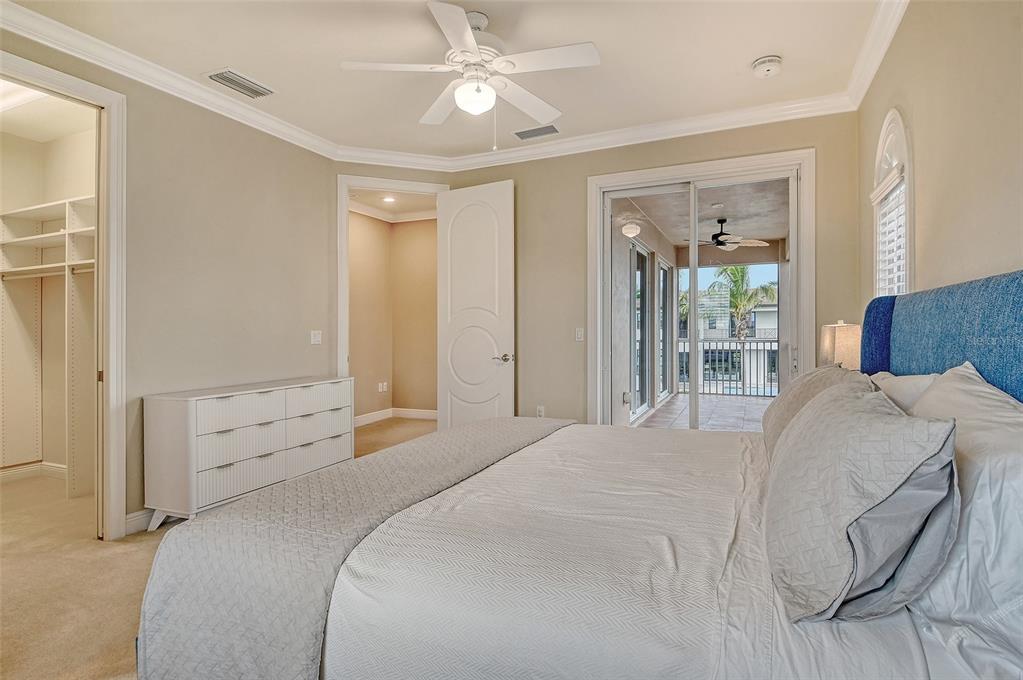 591 Putting Green Lane Longboat Key, FL 34228 - Photo 45 of 68 a bedroom with a bed and a chandelier