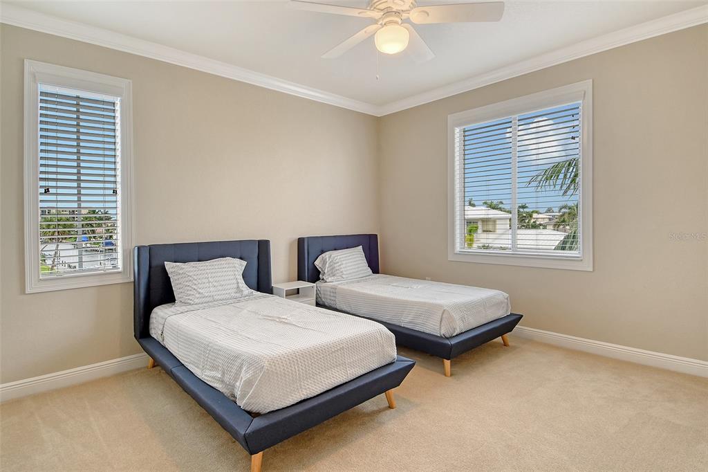 591 Putting Green Lane Longboat Key, FL 34228 - Photo 48 of 68 a bedroom with two beds and a window