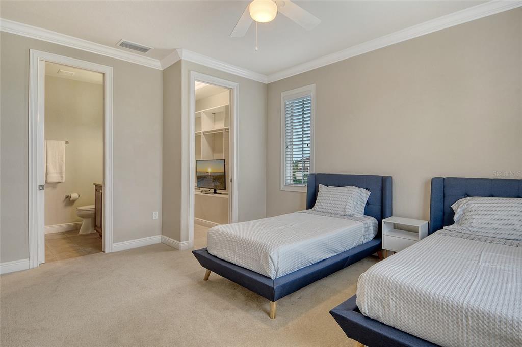 591 Putting Green Lane Longboat Key, FL 34228 - Photo 49 of 68 a spacious bedroom with two beds and a chandelier
