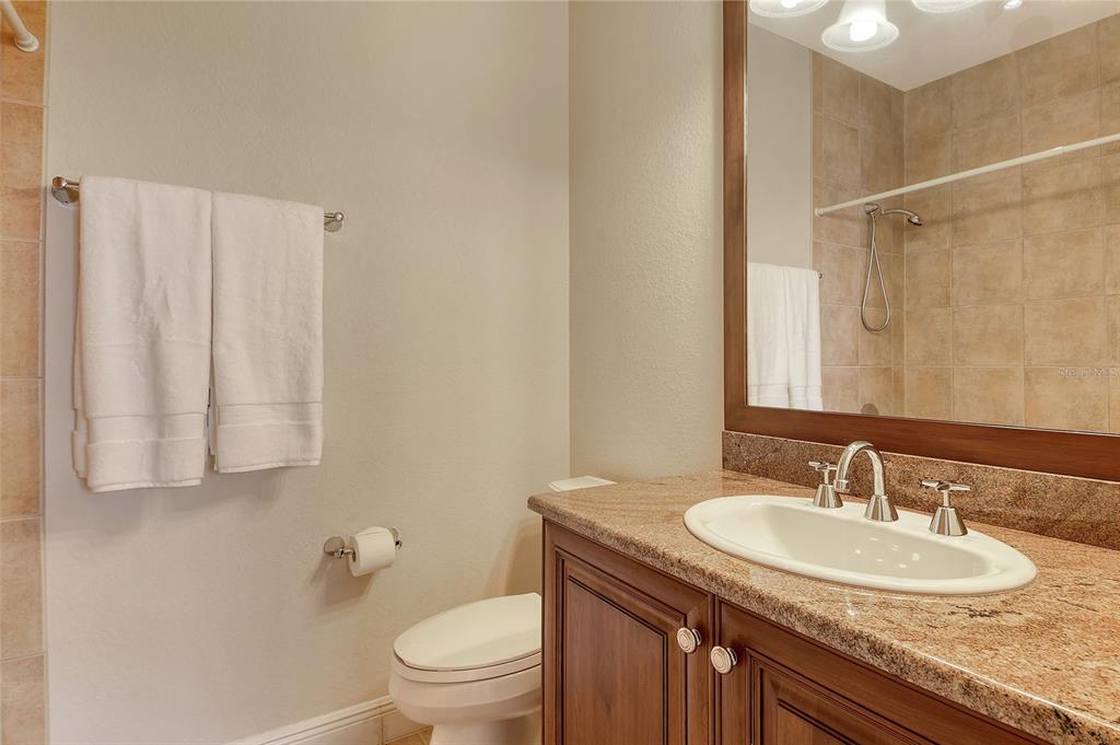 591 Putting Green Lane Longboat Key, FL 34228 - Photo 50 of 68 a bathroom with a granite countertop sink and a mirror with toilet