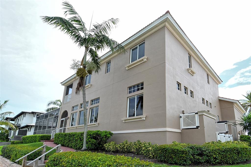 591 Putting Green Lane Longboat Key, FL 34228 - Photo 66 of 68 a front view of a house with a yard