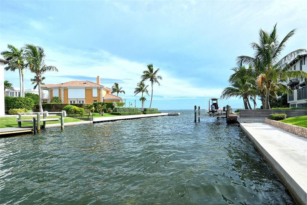 591 Putting Green Lane Longboat Key, FL 34228 - Photo 67 of 68 a view of a swimming pool with a table and chairs