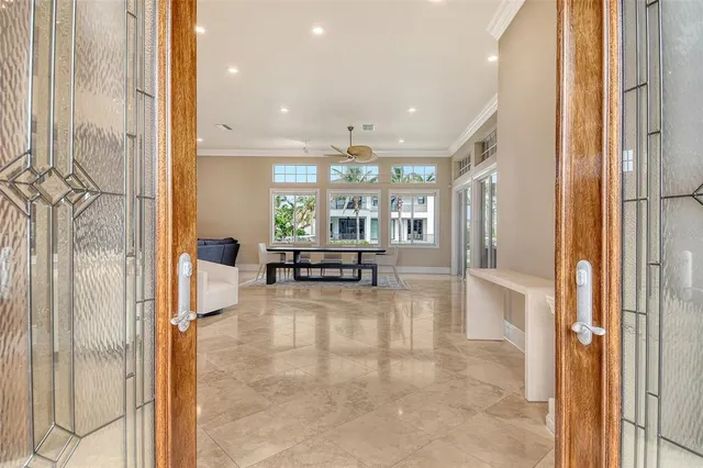 a living room with furniture kitchen view and a chandelier