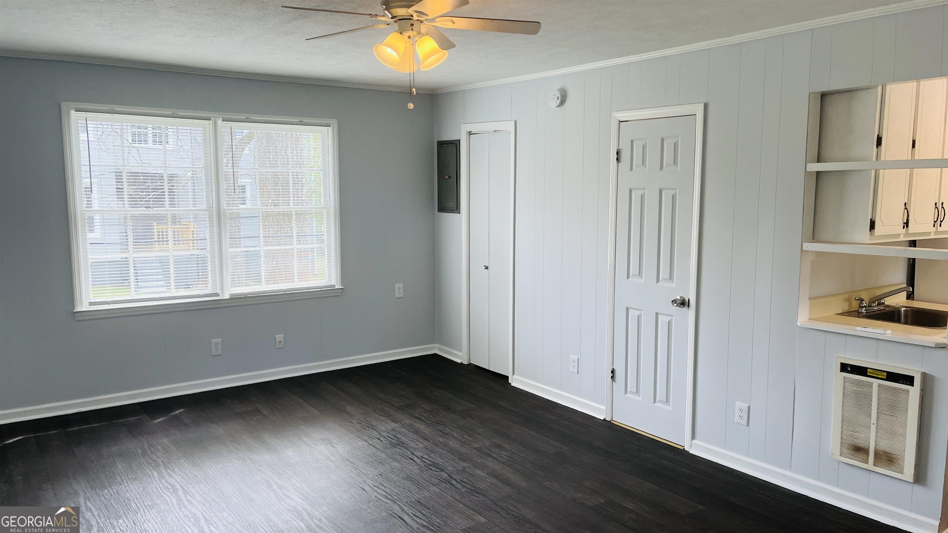 601 West Haralson Street, Unit 10 LaGrange, GA 30240 - Photo 3 of 11 a view of an empty room with window and wooden floor