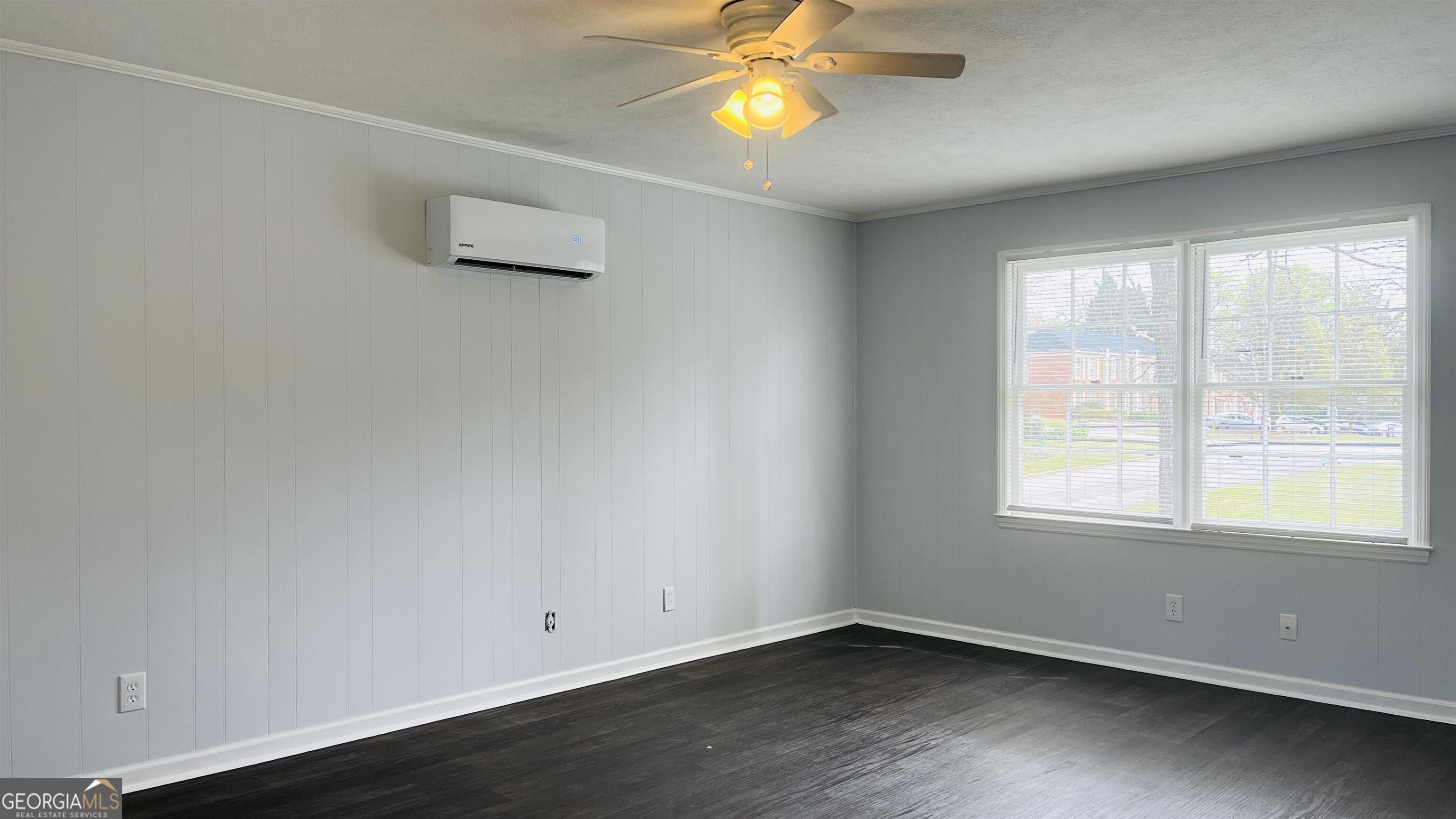 601 West Haralson Street, Unit 10 LaGrange, GA 30240 - Photo 5 of 11 an empty room with wooden floor and windows