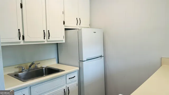 a kitchen with a sink and refrigerator