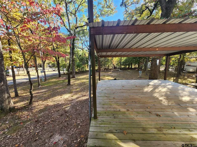 a view of a yard with wooden fence