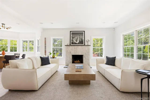 a living room with furniture fireplace and window
