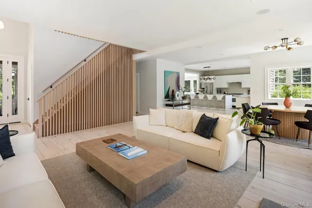 a living room with furniture rug and wooden floor