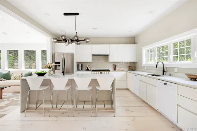 a large kitchen with kitchen island granite countertop a table and chairs
