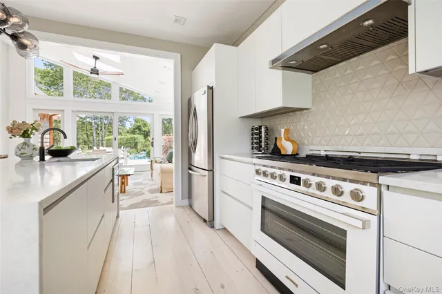 a kitchen with a stove a sink and a refrigerator
