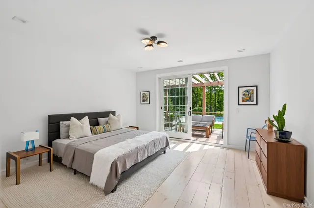 a bedroom with a large bed and a large window