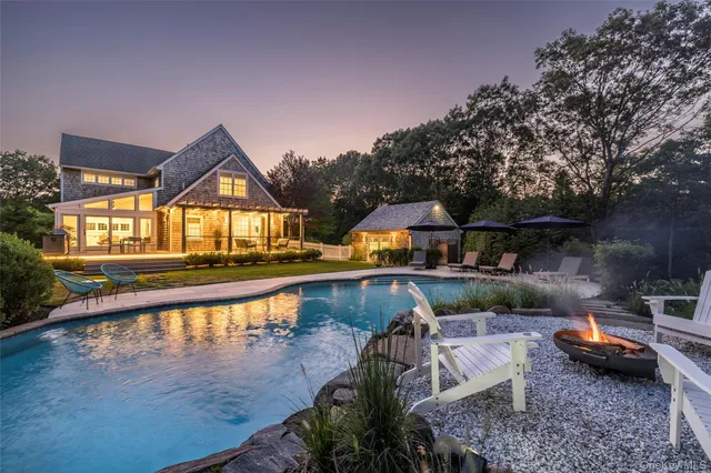 a view of a house with pool and furniture