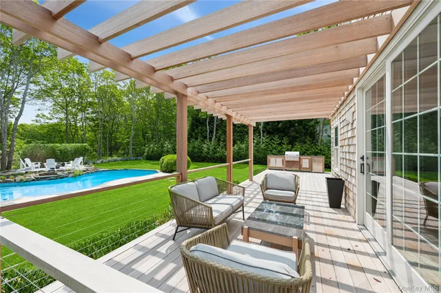 a view of a patio with chairs and floor to ceiling window