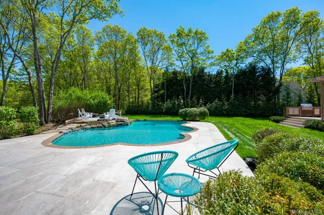 a view of a backyard with sitting area and garden