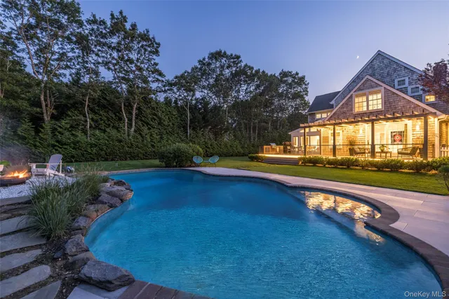 a view of swimming pool and deck in the backyard