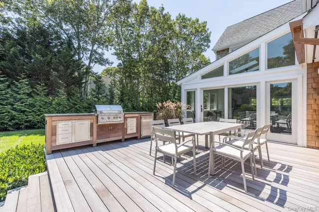 a view of a patio with table and chairs and wooden floor
