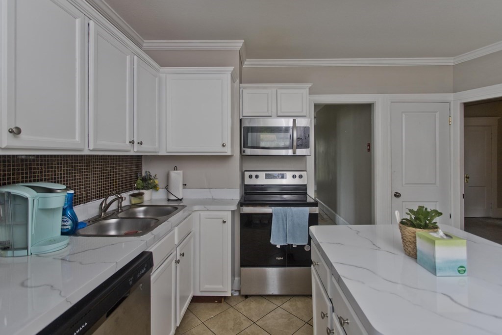 145 Carr Street Springfield, MA 01118 - Photo 9 of 41 a kitchen with a sink cabinets and appliances