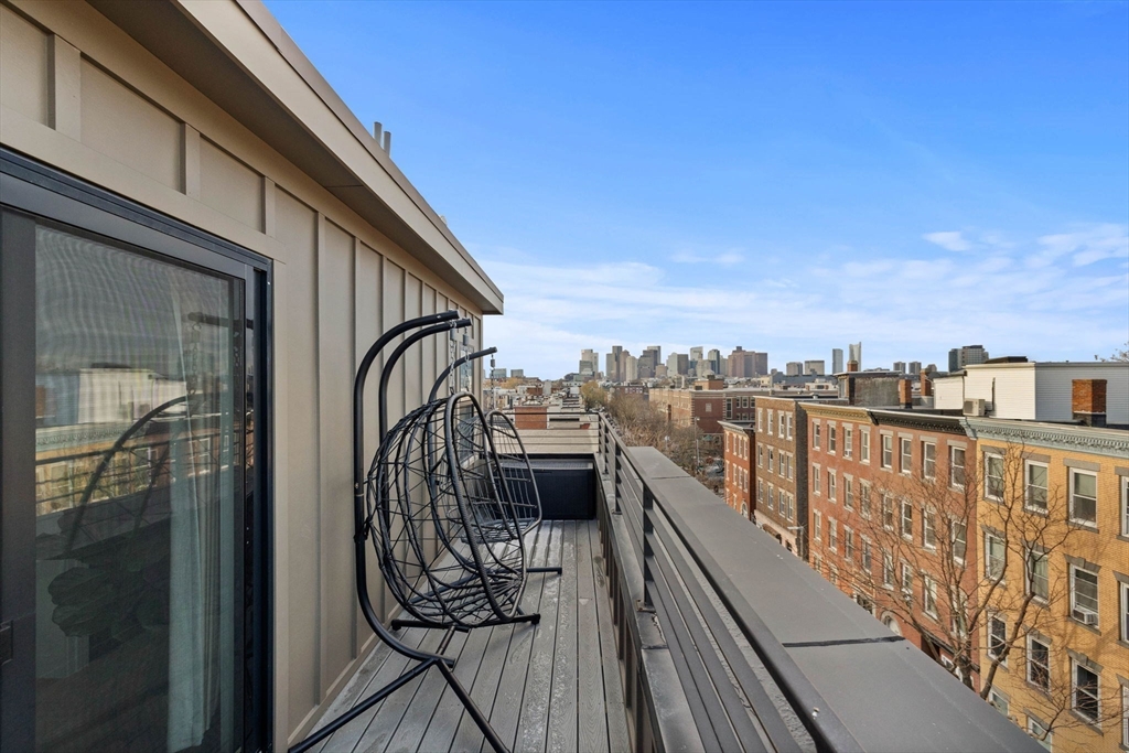 161 Cottage Street, Unit 9 Boston, MA 02128 - Photo 16 of 26 a view of balcony with wooden floor and fence