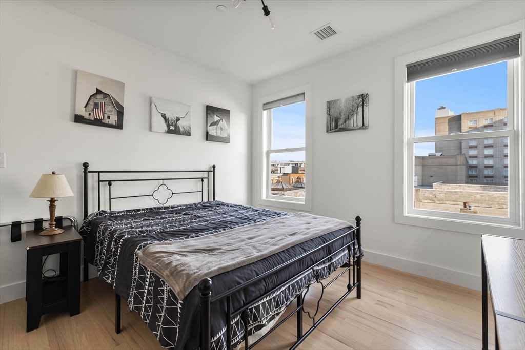 161 Cottage Street, Unit 9 Boston, MA 02128 - Photo 18 of 26 a bedroom with a bed and a window
