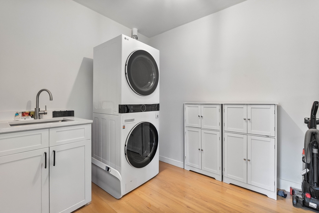 161 Cottage Street, Unit 9 Boston, MA 02128 - Photo 24 of 26 a utility room with sink dryer and washer