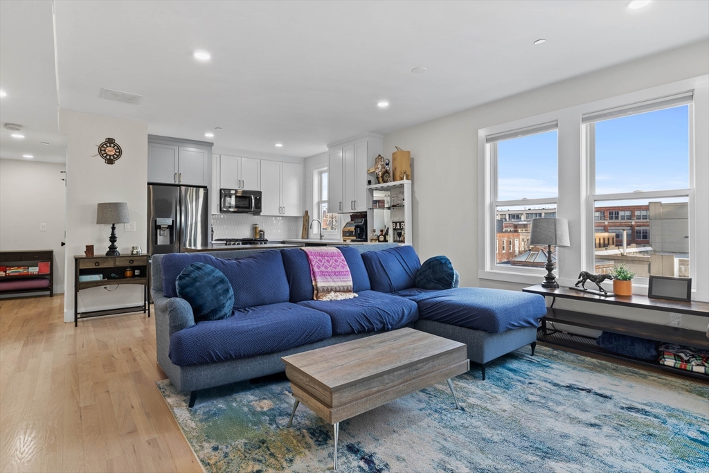 161 Cottage Street, Unit 9 Boston, MA 02128 - Photo 5 of 26 a living room with furniture and a large window