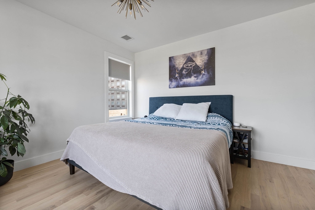 161 Cottage Street, Unit 9 Boston, MA 02128 - Photo 9 of 26 a bedroom with a bed and a potted plant