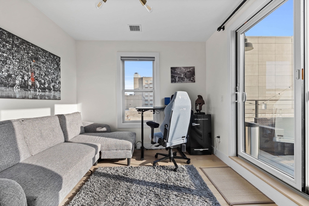 161 Cottage Street, Unit 9 Boston, MA 02128 - Photo 10 of 26 a living room with furniture a rug and white walls