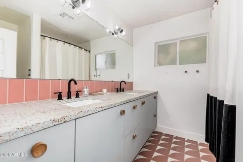 a living room with furniture and large windows