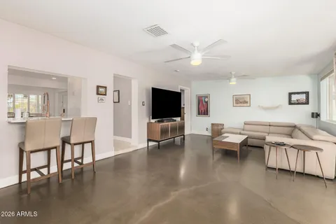 a living room with furniture a rug and a large window