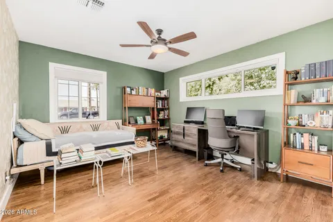 a view of a workspace with furniture and a rug
