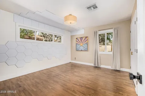 a kitchen with stainless steel appliances a wooden floor cabinets and a dining table