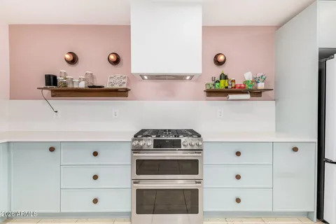 a stove top oven sitting inside of a kitchen