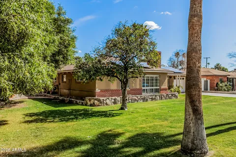 a view of swimming pool with a yard and trees