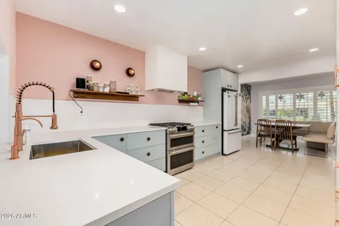 a kitchen with refrigerator and cabinets
