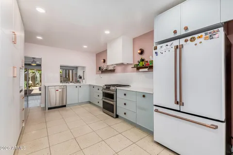 a kitchen with stainless steel appliances a refrigerator sink and cabinets