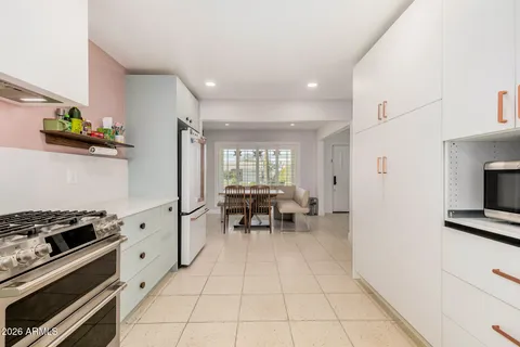 a living room with furniture a rug and a table
