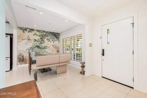 a living room with furniture large window and fireplace