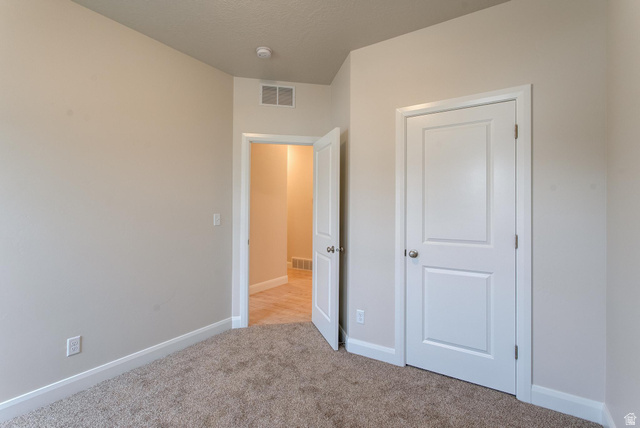 1512 West 600 North, Unit O4A Mapleton, UT 84664 - Photo 18 of 24 Unfurnished bedroom featuring light colored carpet and baseboards