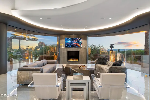 a living room with fireplace furniture and a large window