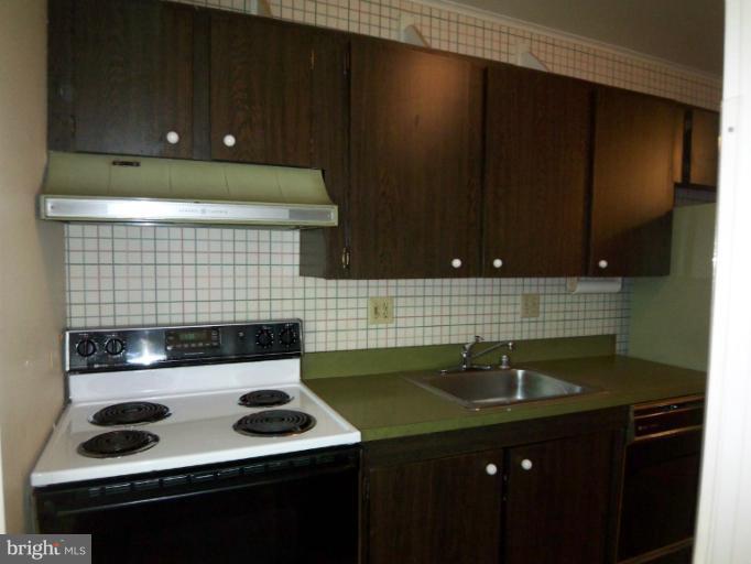 11080 Saffold Way Reston, VA 20190 - Photo 12 of 30 a kitchen with a sink and cabinets