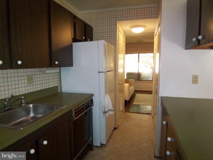 11080 Saffold Way Reston, VA 20190 - Photo 18 of 30 a kitchen that has a sink and a refrigerator