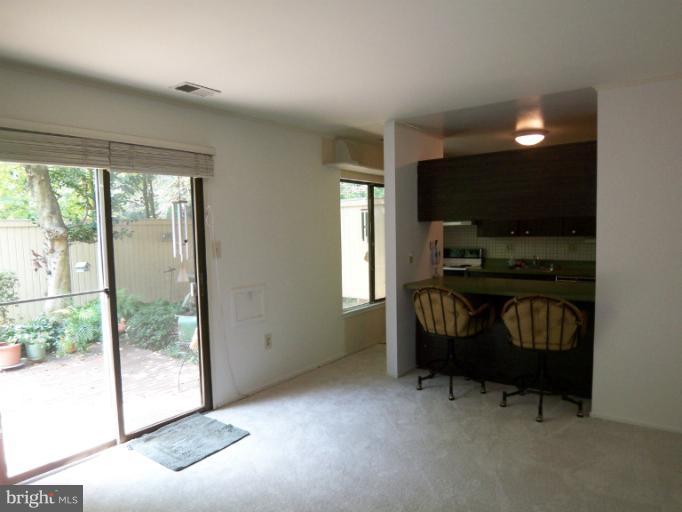 11080 Saffold Way Reston, VA 20190 - Photo 6 of 30 a living room with furniture and a flat screen tv