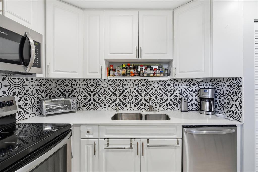 3910 Inverrary Boulevard, Unit 708B Lauderhill, FL 33319 - Photo 16 of 58 a kitchen with appliances a sink and cabinets